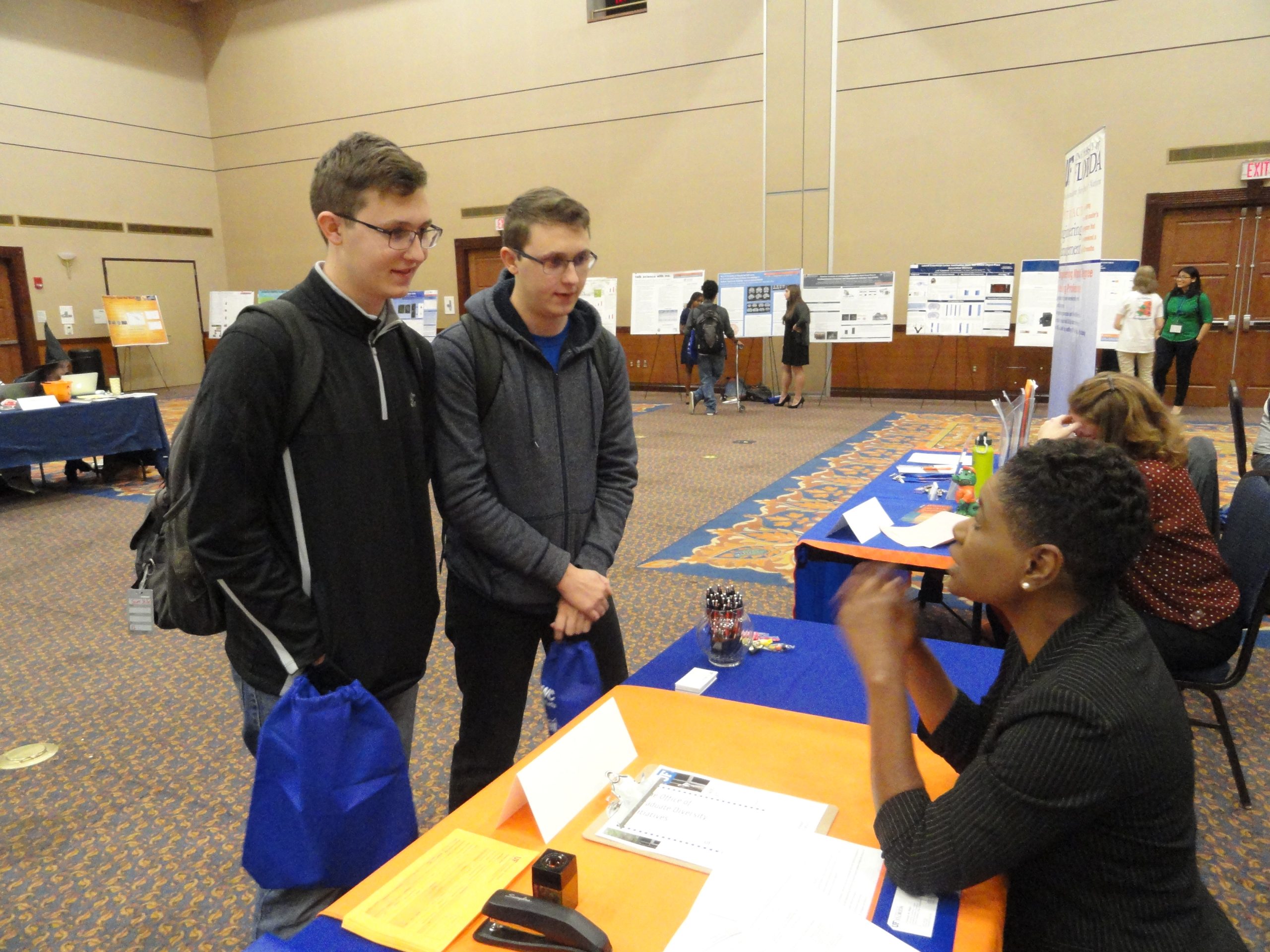 Two students receive information at a career fair booth