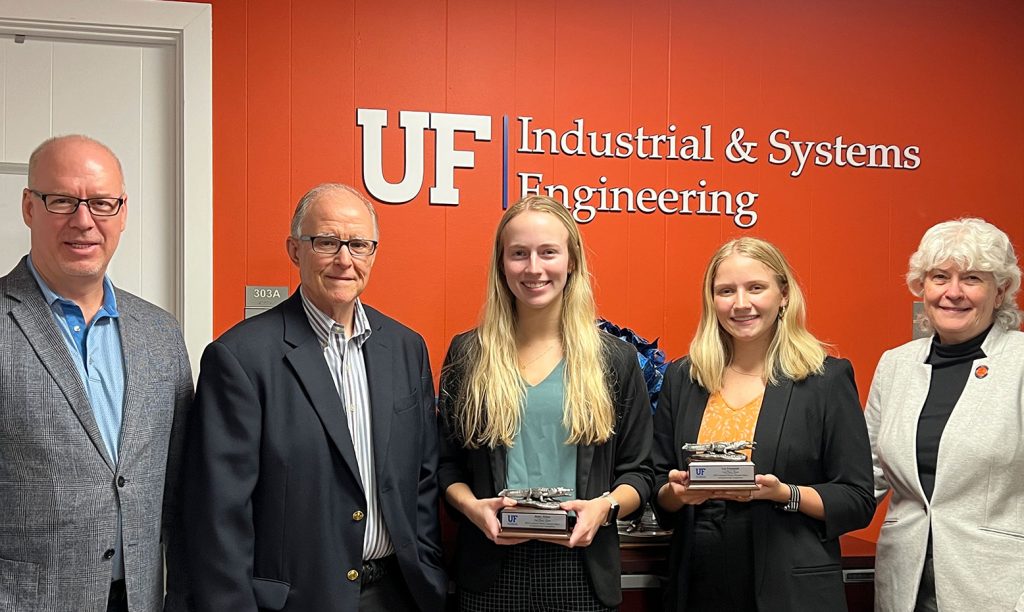 Group photo of ISE chair David Kaber, faculty coach Bill McElroy, engineering seniors Haley Scites and Lia Frumenti, and dean Cammy Abernathy, standing together.