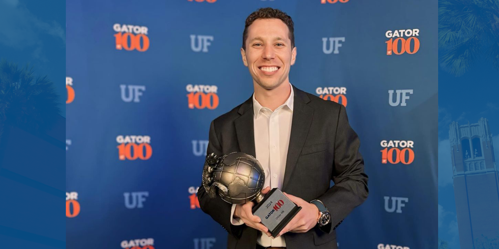 A picture of Scott Bartnick holding his Gator100 award.