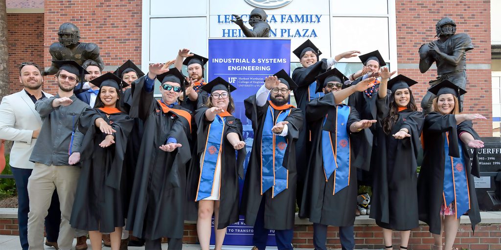 Members of OEM’s 2025 spring graduating class celebrate next to the Swamp in May. Photo by Dave Schlenker