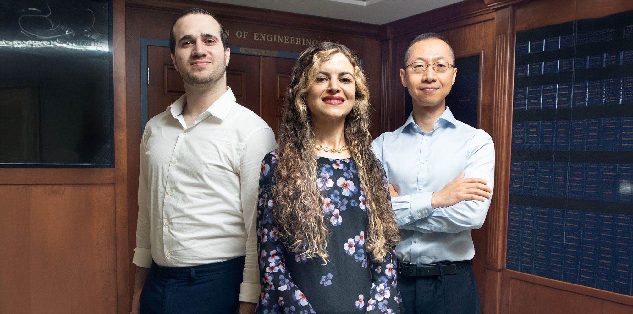 New Industrial and Systems Engineering faculty members Jad Atweh, Fatemeh Nosrat, and Jia (Peter) Liu standing in front of the dean’s office in Weil Hall.