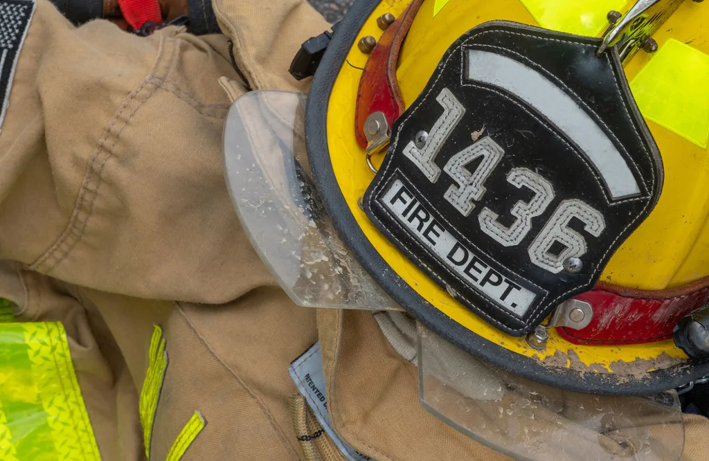 A firefighter helmet is shown on top of gear.
