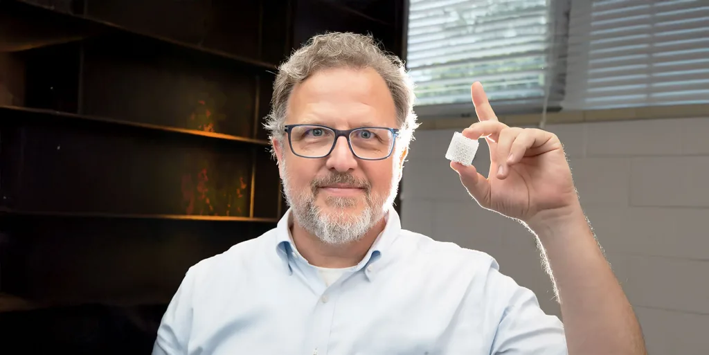 Eric MacDonald holds a 3D-printed ceramic Luneburg lens